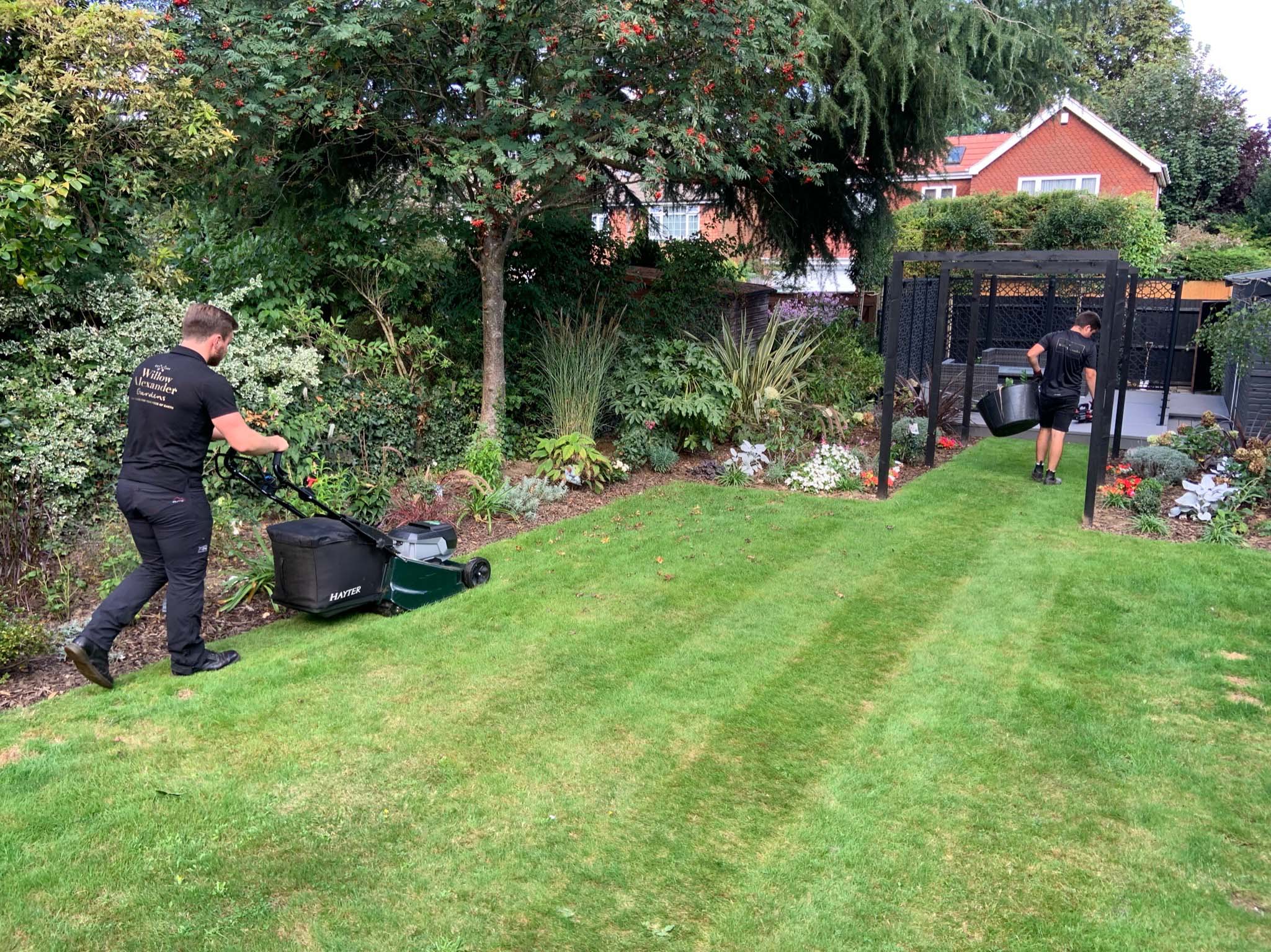 One of the Willow Alexander Gardens team mowing a lawn