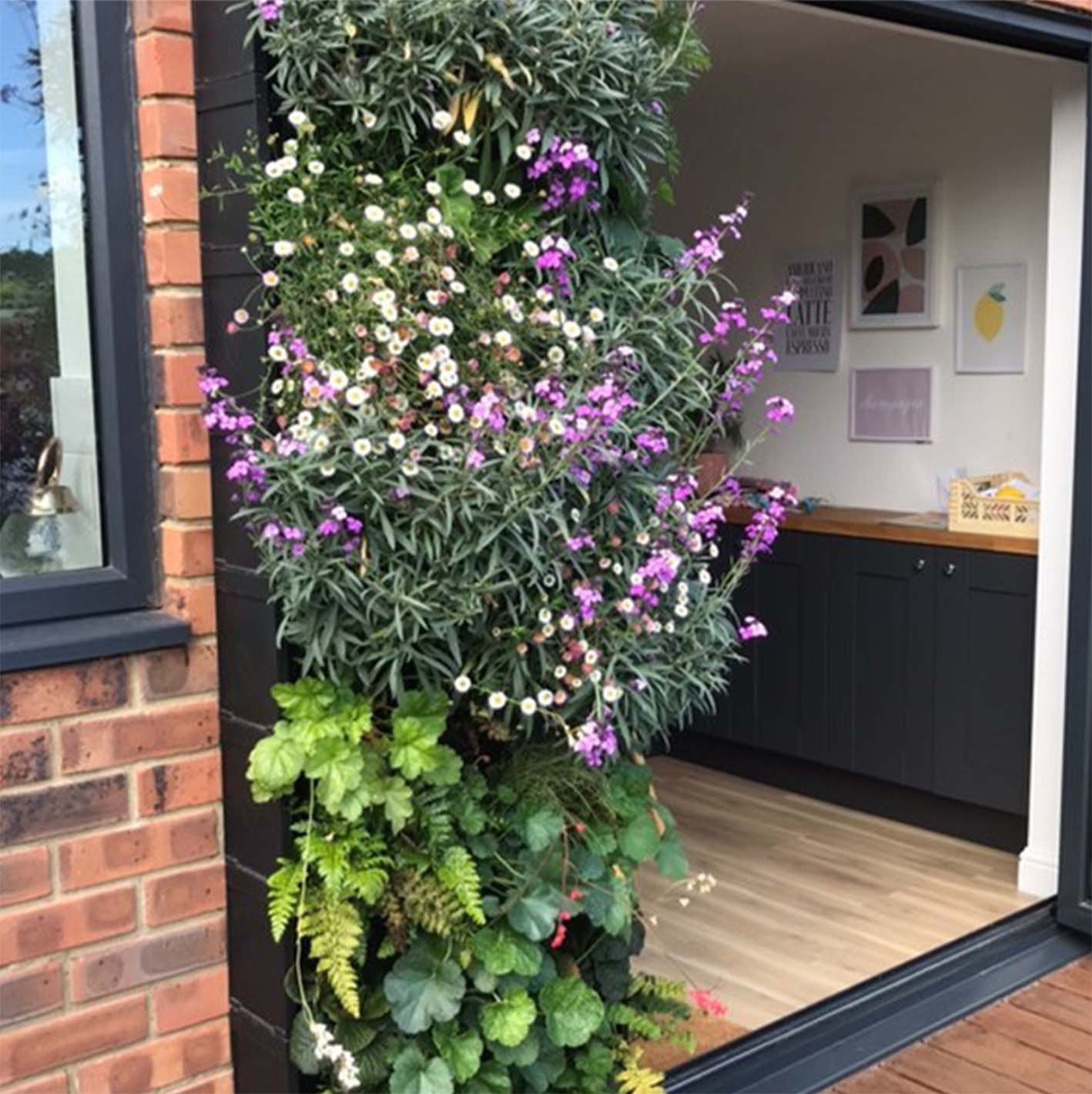A colourful Vertical Garden full of purple and white plants