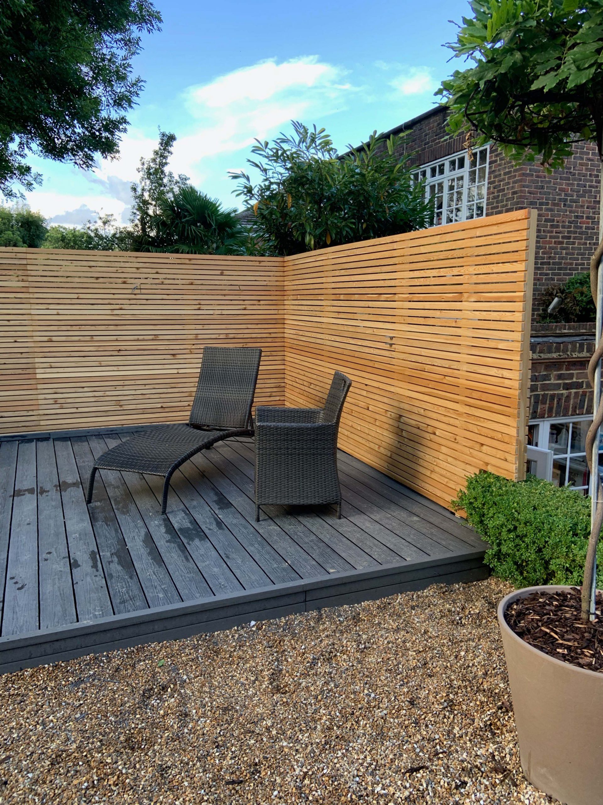 some modern black outdoor furniture sitting on a completed sustainable composite decking area