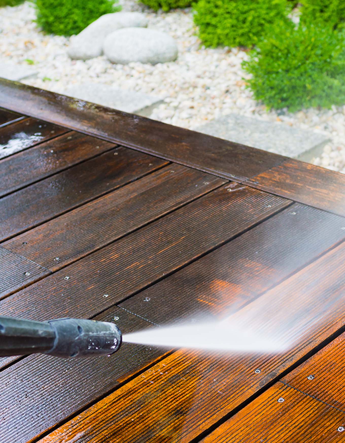 One of the Willow team jet-cleaning some decking