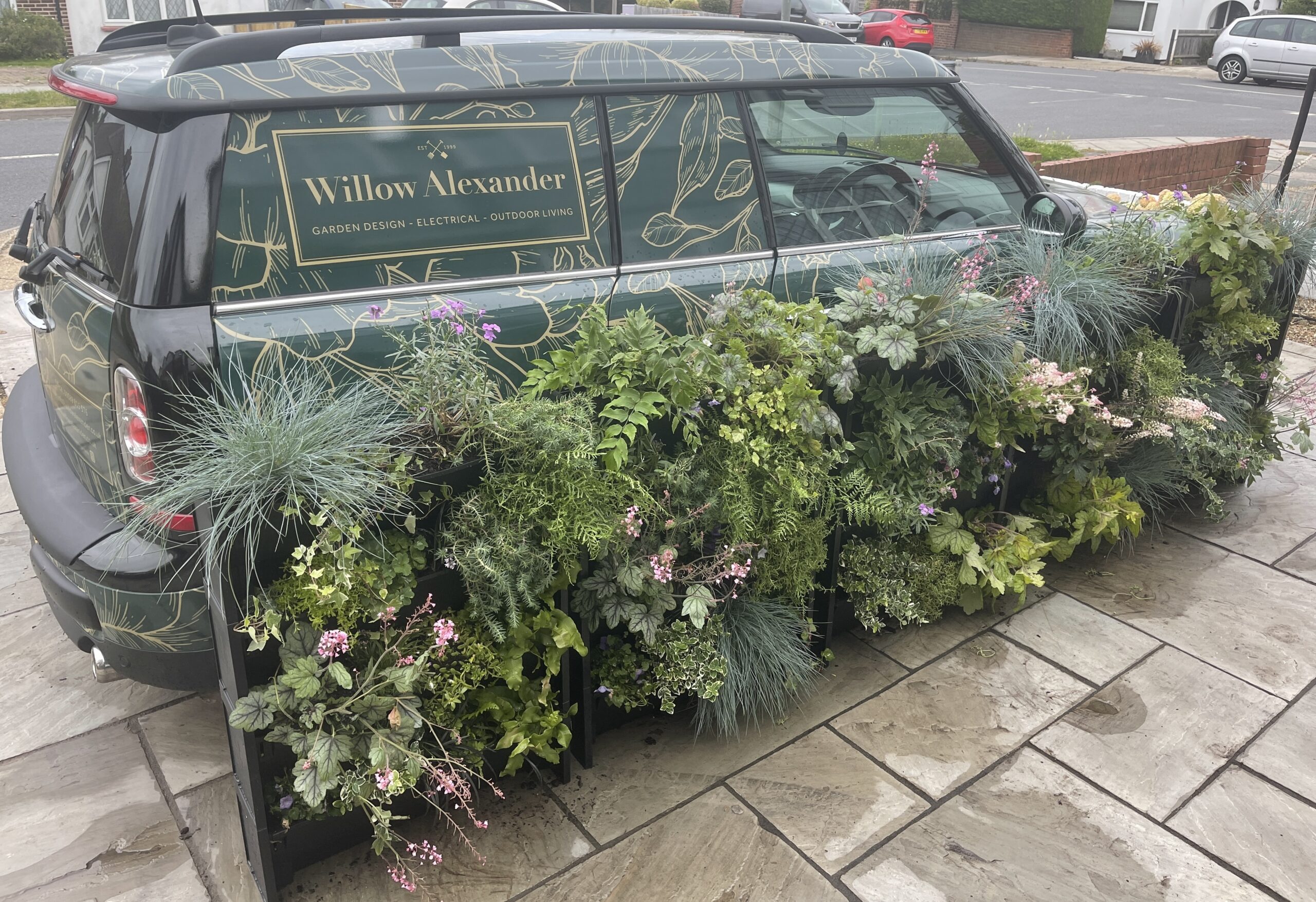 A PlantBox Garden in front of a Willow Alexander Gardens vehicle